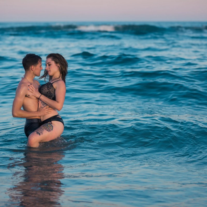 Couple posing in the ocean