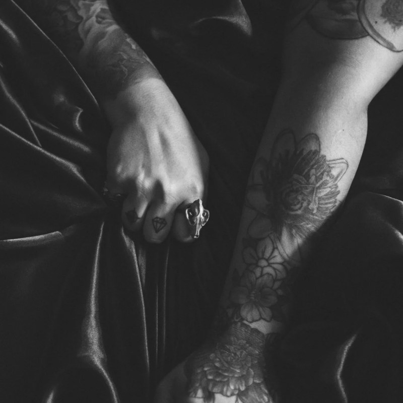 black and white image of woman in lingerie on bed