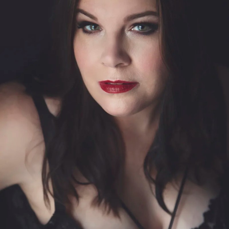 brunette woman with red lipstick during boudoir session