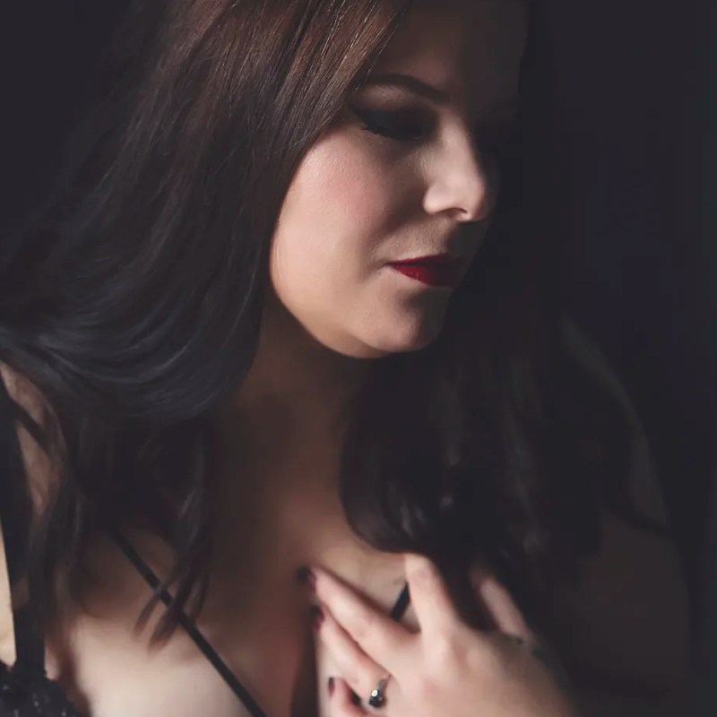 brunette woman with red lipstick during boudoir session